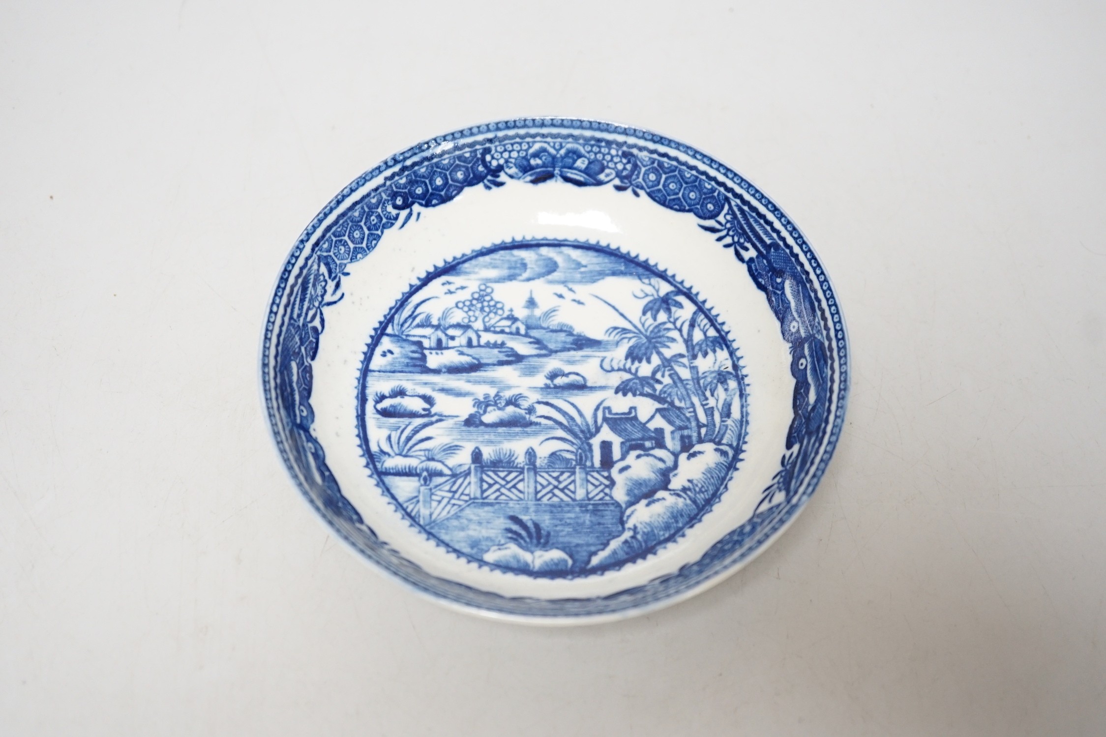 An 18th century Caughley teabowl and saucer printed with the uncommon Fence and House pattern. 6cm tall overall